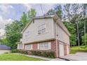 Two-story home with brick foundation, vinyl siding, and a convenient attached garage at 803 Cedar Lake Se Dr, Conyers, GA 30094