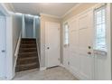 Inviting foyer featuring a staircase and a bright, naturally lit entrance at 803 Cedar Lake Se Dr, Conyers, GA 30094