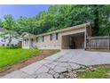View of the home with an extended driveway and an adjacent carport at 220 Harwell Nw Rd, Atlanta, GA 30331