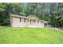 Well-kept single-story home featuring a lush front lawn and inviting entrance at 220 Harwell Nw Rd, Atlanta, GA 30331