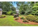 Lush backyard featuring mature landscaping, pine straw, and a variety of shrubs and plantings at 2786 Olde Gate Ct, Snellville, GA 30078