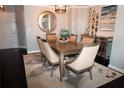 Elegant dining room featuring a modern chandelier, stylish mirror and seating for six at 3475 Oak Valley Ne Rd # 980, Atlanta, GA 30326
