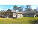 Spacious backyard featuring a screened-in porch, a deck and ample outdoor space at 4841 Partee Trl, Social Circle, GA 30025