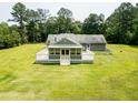 Aerial view of a home featuring a spacious screened-in porch and an expansive backyard at 4841 Partee Trl, Social Circle, GA 30025