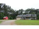 Traditional home with a two-car garage and shed, nestled on a large lot with mature trees at 4841 Partee Trl, Social Circle, GA 30025
