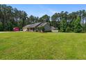 Spacious home with a large yard and a storage shed in the backyard at 4841 Partee Trl, Social Circle, GA 30025