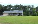 Charming single-story home with a well-maintained lawn and attached two-car garage at 4841 Partee Trl, Social Circle, GA 30025