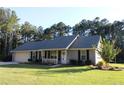 Charming single story home with manicured lawn, attached garage, and inviting front porch at 4841 Partee Trl, Social Circle, GA 30025