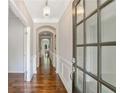 Elegant foyer featuring hardwood floors, decorative molding, and a stylish chandelier at 667 Creswell Park, Smyrna, GA 30082
