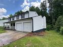 This home includes an attached two car garage and a landscaped yard at 2691 Old South Dr, Jonesboro, GA 30236