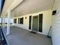 Covered front porch with a green door, and black shutters at 2691 Old South Dr, Jonesboro, GA 30236