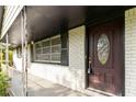 Covered front porch with decorative front door and white painted brick at 6873 Church St, Riverdale, GA 30274