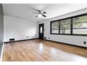 Bright living room with hardwood floors, fresh paint, and modern ceiling fan at 6873 Church St, Riverdale, GA 30274