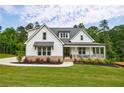 Charming two-story white farmhouse with covered front porch at 130 Lapis Lake Pt, Fayetteville, GA 30215