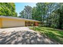 Ranch-style home featuring a two-car garage and a well-manicured front lawn at 213 Linda Dr, Tucker, GA 30084