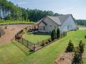 Backyard with a fenced in area, patio set and umbrella, and mature trees at 400 Southland Cir, Canton, GA 30115