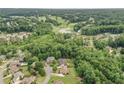 Aerial view of the home's location, showcasing its proximity to green spaces, golf course and pond at 602 Davenport Pl, Canton, GA 30115