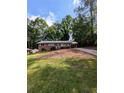 Charming brick home with a single-story layout and a cozy carport, nestled on a hill with mature trees at 3130 Gay Dr, Decatur, GA 30032