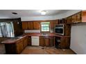 Kitchen with wood cabinets, stainless steel appliances, and a window overlooking the backyard at 3130 Gay Dr, Decatur, GA 30032