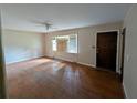 Spacious living room featuring hardwood floors, natural light from the window, and neutral-colored walls at 3130 Gay Dr, Decatur, GA 30032