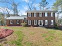 Well-maintained two-story brick home with a spacious front yard and classic curb appeal at 4076 Shady Nw Cir, Lilburn, GA 30047