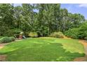 Expansive backyard with lush green grass and a playground, perfect for outdoor activities at 4343 Sprucebough Dr, Marietta, GA 30062