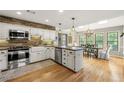 Bright kitchen featuring white cabinets, stainless steel appliances, and an adjacent dining area at 4343 Sprucebough Dr, Marietta, GA 30062