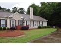 Well-maintained ranch home with manicured lawn, mature trees, and inviting curb appeal at 179 Camry Ln, Grayson, GA 30017