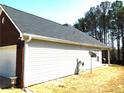 Rear of a home featuring low maintenance vinyl siding and a new roof and well-kept lawn at 40 Pebble Brooke Ct, Covington, GA 30016