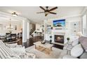 Inviting living room with a fireplace, built-in shelves, and a comfortable seating area at 4155 Brookview Dr, Cumming, GA 30040
