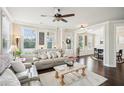 Bright living room featuring hardwood floors, large windows, and a cozy seating arrangement at 4155 Brookview Dr, Cumming, GA 30040
