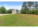Two-story home with a well-manicured lawn and mature trees at 5 White Pines Dr, Dallas, GA 30157