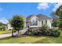 Charming two-story home with white siding, beautiful landscaping and a well-maintained lawn at 108 Faraday Dr, Douglasville, GA 30134
