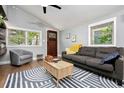 Inviting living room with a gray sofa, area rug, and natural light from large windows at 677 Holmes Nw St, Atlanta, GA 30318