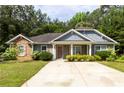 Attractive home with stone and siding exterior, enhanced by lush landscaping and mature trees at 6770 Gordon Manor Sw Ct, Mableton, GA 30126