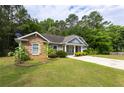 Well-maintained home featuring a stone facade and pleasant front yard with green grass at 6770 Gordon Manor Sw Ct, Mableton, GA 30126