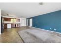 Spacious living area with adjacent kitchen, suitable for renovation at 6770 Gordon Manor Sw Ct, Mableton, GA 30126