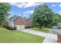 Beautiful two-story brick home with attached garage and a neatly landscaped front yard at 10735 Pinewalk Forest Cir, Alpharetta, GA 30022