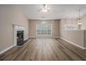 Spacious living room with a fireplace, vaulted ceilings, and large windows at 1501 Buckingham, Stockbridge, GA 30281