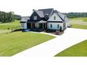 A stunning two-story home with a large, well-maintained lawn and a bright, white driveway at 152 Palisade Dr, Rydal, GA 30171