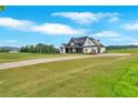 Spacious front lawn of a modern farmhouse with a long driveway and picturesque countryside views at 152 Palisade Dr, Rydal, GA 30171