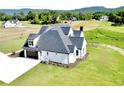 Two-story home featuring a attached garage, pristine lawn, and mountain views at 152 Palisade Dr, Rydal, GA 30171
