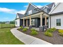 Inviting front porch with stone pillars and wood posts, complemented by manicured landscaping at 152 Palisade Dr, Rydal, GA 30171
