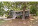 Charming home featuring a welcoming front porch, lush landscaping, and inviting curb appeal at 3404 Broxton Mill Way, Snellville, GA 30039