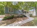 Charming home featuring a welcoming front porch, lush landscaping, and inviting curb appeal at 3404 Broxton Mill Way, Snellville, GA 30039