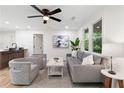 Bright living room with updated ceiling fan and natural light from surrounding windows offering a relaxing space at 2871 Tucker Mill Sw Rd, Conyers, GA 30094