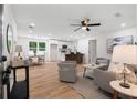 Open-concept living room seamlessly connects to the kitchen and dining area, featuring hardwood floors and neutral decor at 2871 Tucker Mill Sw Rd, Conyers, GA 30094