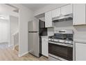Well-lit kitchen boasts stainless steel appliances and white cabinets, complemented by sleek countertops at 2426 Corner Shoals Dr, Decatur, GA 30034