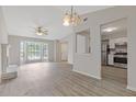 Open concept living room featuring luxury vinyl plank flooring, modern lighting and white kitchen at 2426 Corner Shoals Dr, Decatur, GA 30034