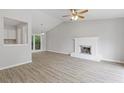 Bright living room featuring modern flooring, a fireplace, and sliding glass doors at 2426 Corner Shoals Dr, Decatur, GA 30034